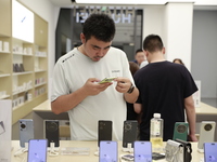 People are shopping for a Huawei nova Flip foldable mobile phone at a Huawei mobile phone store in Xi'an, Shaanxi province, China, on August...