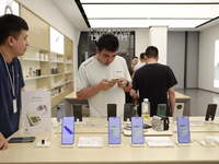 People are shopping for a Huawei nova Flip foldable mobile phone at a Huawei mobile phone store in Xi'an, Shaanxi province, China, on August...