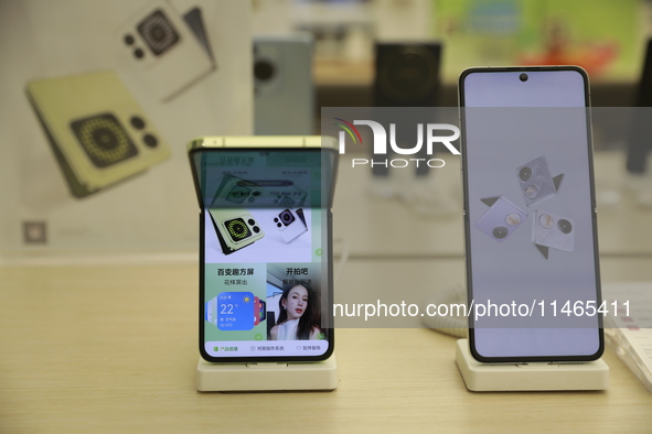 People are shopping for a Huawei nova Flip foldable mobile phone at a Huawei mobile phone store in Xi'an, Shaanxi province, China, on August...