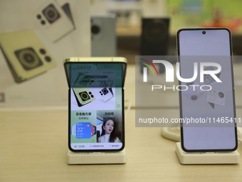 People are shopping for a Huawei nova Flip foldable mobile phone at a Huawei mobile phone store in Xi'an, Shaanxi province, China, on August...