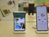 People are shopping for a Huawei nova Flip foldable mobile phone at a Huawei mobile phone store in Xi'an, Shaanxi province, China, on August...