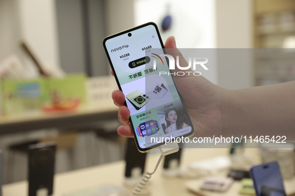 People are shopping for a Huawei nova Flip foldable mobile phone at a Huawei mobile phone store in Xi'an, Shaanxi province, China, on August...