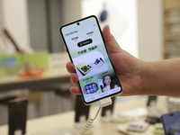 People are shopping for a Huawei nova Flip foldable mobile phone at a Huawei mobile phone store in Xi'an, Shaanxi province, China, on August...