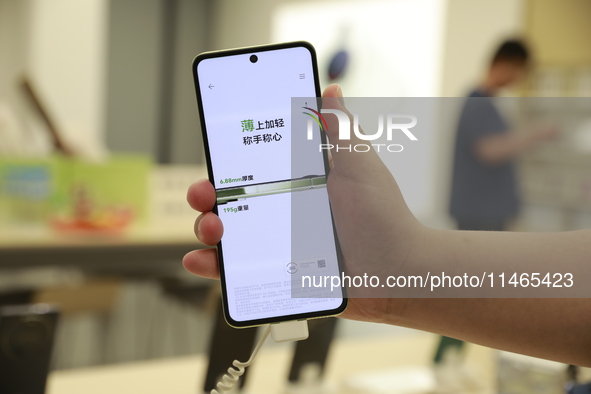 People are shopping for a Huawei nova Flip foldable mobile phone at a Huawei mobile phone store in Xi'an, Shaanxi province, China, on August...