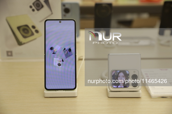 People are shopping for a Huawei nova Flip foldable mobile phone at a Huawei mobile phone store in Xi'an, Shaanxi province, China, on August...