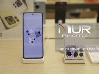 People are shopping for a Huawei nova Flip foldable mobile phone at a Huawei mobile phone store in Xi'an, Shaanxi province, China, on August...