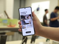 People are shopping for a Huawei nova Flip foldable mobile phone at a Huawei mobile phone store in Xi'an, Shaanxi province, China, on August...