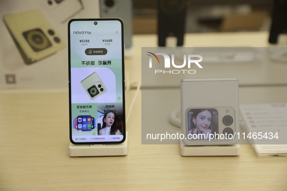 People are shopping for a Huawei nova Flip foldable mobile phone at a Huawei mobile phone store in Xi'an, Shaanxi province, China, on August...