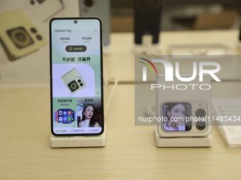 People are shopping for a Huawei nova Flip foldable mobile phone at a Huawei mobile phone store in Xi'an, Shaanxi province, China, on August...