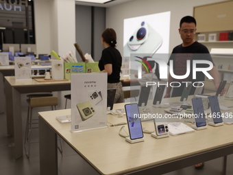 People are shopping for a Huawei nova Flip foldable mobile phone at a Huawei mobile phone store in Xi'an, Shaanxi province, China, on August...