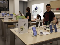 People are shopping for a Huawei nova Flip foldable mobile phone at a Huawei mobile phone store in Xi'an, Shaanxi province, China, on August...