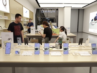 People are shopping for a Huawei nova Flip foldable mobile phone at a Huawei mobile phone store in Xi'an, Shaanxi province, China, on August...