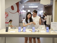 People are shopping for a Huawei nova Flip foldable mobile phone at a Huawei mobile phone store in Xi'an, Shaanxi province, China, on August...