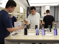 People are shopping for a Huawei nova Flip foldable mobile phone at a Huawei mobile phone store in Xi'an, Shaanxi province, China, on August...