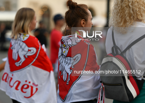 KRAKOW, POLAND - AUGUST 9:
Members of the Belarusian diaspora, many displaying white-red-white opposition flags, gather at Krakow's Market S...