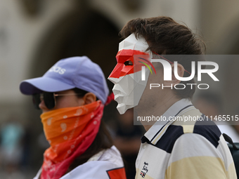 KRAKOW, POLAND - AUGUST 9:
Members of the Belarusian diaspora, wearing masks to maintain anonymity, gather at Krakow's Market Square for the...