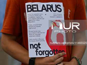 KRAKOW, POLAND - AUGUST 9:
A member of the Belarusian diaspora holds a poster with the inscription 'Belarus Not FOrgotten', during the Day o...