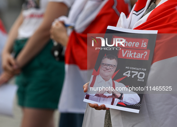 KRAKOW, POLAND - AUGUST 9:
A member of the Belarusian diaspora holds a poster with the inscription 'Where is Viktar? No contact for 470 days...