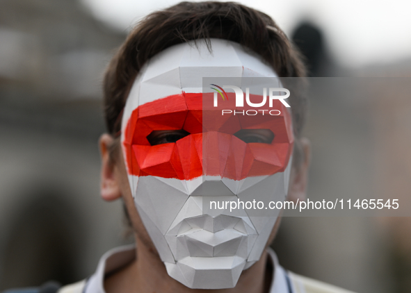 KRAKOW, POLAND - AUGUST 9:
Members of the Belarusian diaspora, wearing masks to maintain anonymity, gather at Krakow's Market Square for the...