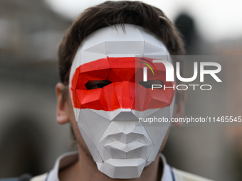 KRAKOW, POLAND - AUGUST 9:
Members of the Belarusian diaspora, wearing masks to maintain anonymity, gather at Krakow's Market Square for the...