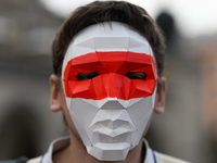 KRAKOW, POLAND - AUGUST 9:
Members of the Belarusian diaspora, wearing masks to maintain anonymity, gather at Krakow's Market Square for the...