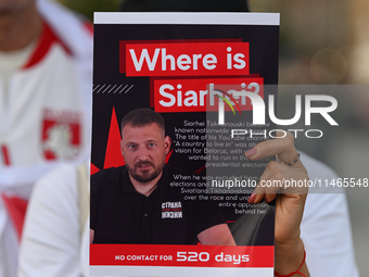 KRAKOW, POLAND - AUGUST 9:
A member of the Belarusian diaspora holds a poster with the inscription 'Where is Siarhei? No contact for 520 day...