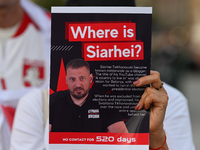 KRAKOW, POLAND - AUGUST 9:
A member of the Belarusian diaspora holds a poster with the inscription 'Where is Siarhei? No contact for 520 day...