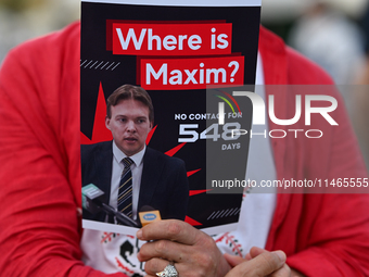 KRAKOW, POLAND - AUGUST 9:
A member of the Belarusian diaspora holds a poster with the inscription 'Where is Maxim? No contact for 548 days,...