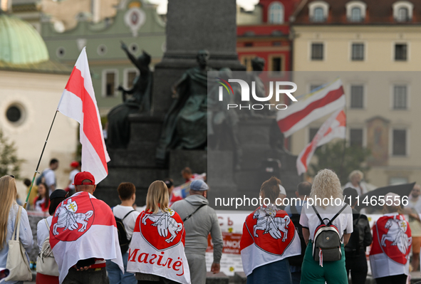 KRAKOW, POLAND - AUGUST 9:
Members of the Belarusian diaspora, many displaying white-red-white opposition flags, gather at Krakow's Market S...