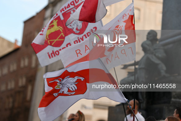 KRAKOW, POLAND - AUGUST 9:
Members of the Belarusian diaspora displaying white-red-white opposition flags as they gather at Krakow's Market...