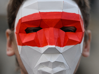 KRAKOW, POLAND - AUGUST 9:
Members of the Belarusian diaspora, wearing masks to maintain anonymity, gather at Krakow's Market Square for the...