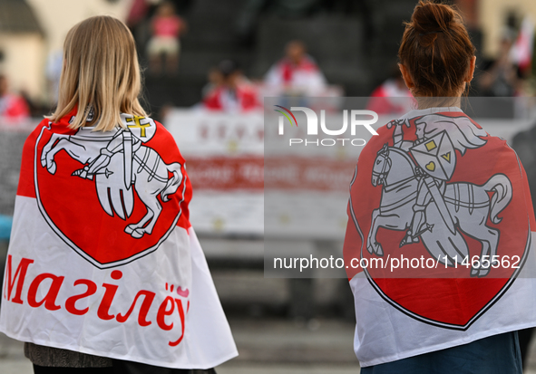 KRAKOW, POLAND - AUGUST 9:
Members of the Belarusian diaspora, many displaying white-red-white opposition flags, gather at Krakow's Market S...