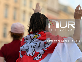 KRAKOW, POLAND - AUGUST 9:
A member of the Belarusian diaspora displaying white-red-white opposition flags during the Day of Solidarity with...