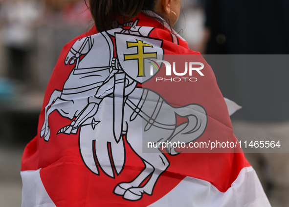 KRAKOW, POLAND - AUGUST 9:
A member of the Belarusian diaspora displaying white-red-white opposition flags during the Day of Solidarity with...