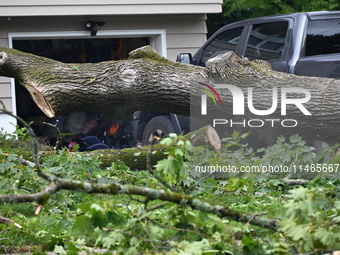 A large tree is uprooting and causing major damage to a home on Wynetta Place during severe weather impacting the northeastern United States...