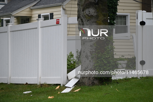 A large tree is damaging a fence, causing power lines to come down, and causing severe damage to a home during severe weather impacting the...