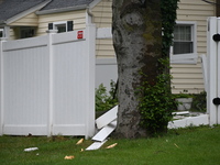 A large tree is damaging a fence, causing power lines to come down, and causing severe damage to a home during severe weather impacting the...