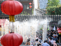 Tourists are waiting to board a boat at a cruise terminal installed with spray cooling devices in Suzhou, China, on August 8, 2024. (