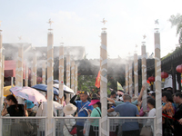 Tourists are waiting to board a boat at a cruise terminal installed with spray cooling devices in Suzhou, China, on August 8, 2024. (