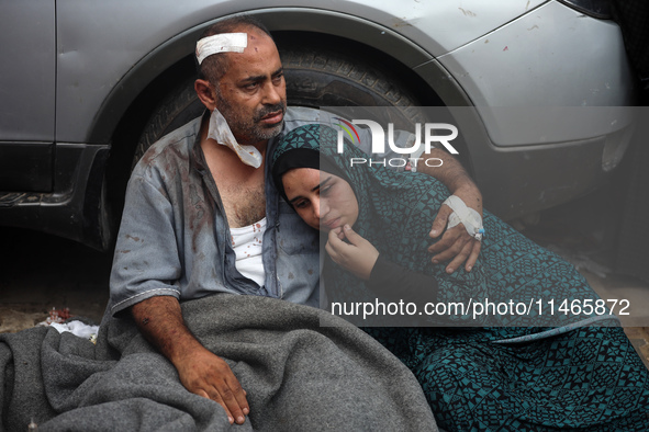 Palestinians are mourning by the bodies of relatives killed in Israeli bombardment on Nuseirat in the central Gaza Strip at Al-Aqsa Martyrs...