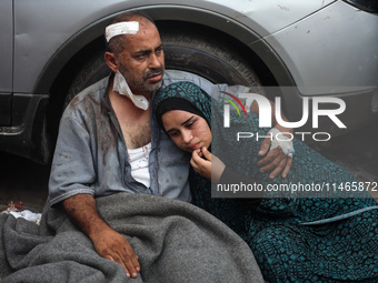 Palestinians are mourning by the bodies of relatives killed in Israeli bombardment on Nuseirat in the central Gaza Strip at Al-Aqsa Martyrs...