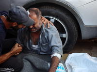 Palestinians are mourning by the bodies of relatives killed in Israeli bombardment on Nuseirat in the central Gaza Strip at Al-Aqsa Martyrs...