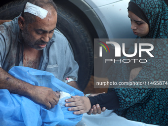 Palestinians are mourning by the bodies of relatives killed in Israeli bombardment on Nuseirat in the central Gaza Strip at Al-Aqsa Martyrs...