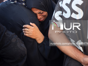 Palestinians are mourning by the bodies of relatives killed in Israeli bombardment on Nuseirat in the central Gaza Strip at Al-Aqsa Martyrs...