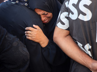 Palestinians are mourning by the bodies of relatives killed in Israeli bombardment on Nuseirat in the central Gaza Strip at Al-Aqsa Martyrs...