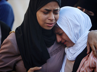 Palestinians are mourning by the bodies of relatives killed in Israeli bombardment on Nuseirat in the central Gaza Strip at Al-Aqsa Martyrs...