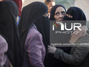 Palestinians are mourning by the bodies of relatives killed in Israeli bombardment on Nuseirat in the central Gaza Strip at Al-Aqsa Martyrs...