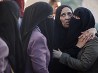 Palestinians are mourning by the bodies of relatives killed in Israeli bombardment on Nuseirat in the central Gaza Strip at Al-Aqsa Martyrs...