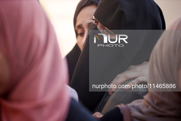 Palestinians are mourning by the bodies of relatives killed in Israeli bombardment on Nuseirat in the central Gaza Strip at Al-Aqsa Martyrs...