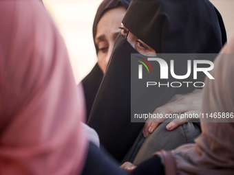 Palestinians are mourning by the bodies of relatives killed in Israeli bombardment on Nuseirat in the central Gaza Strip at Al-Aqsa Martyrs...